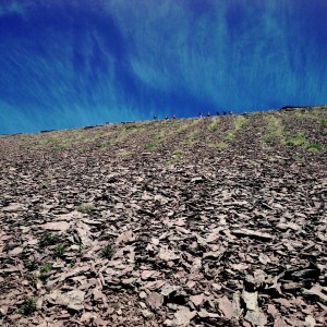 Looking up the scree to people walking the ridge